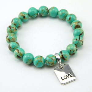 Teal coloured stone bead bracelet with meaningful word charm.