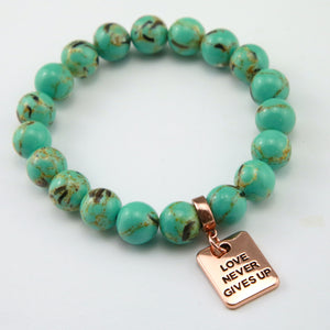 Teal coloured stone bead bracelet with rose gold word charm.
