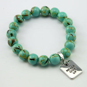 Teal coloured stone bead bracelet with meaningful word charm.