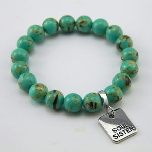 Teal coloured stone bead bracelet with meaningful word charm.