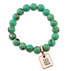 Teal coloured stone bead bracelet with rose gold word charm.