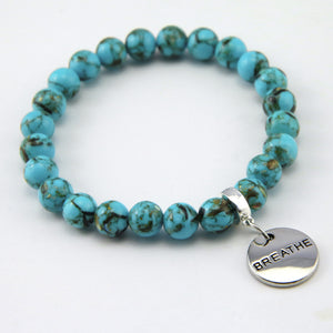 Teal coloured stone bracelet with word charm and silver clip.