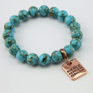 Teal coloured stone bracelet with word charm and rose gold clip.