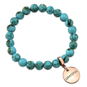 Teal coloured stone bracelet with word charm and rose gold clip.