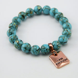 Teal coloured stone bracelet with word charm and rose gold clip.