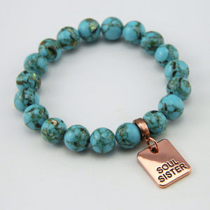 Teal coloured stone bracelet with word charm and rose gold clip.
