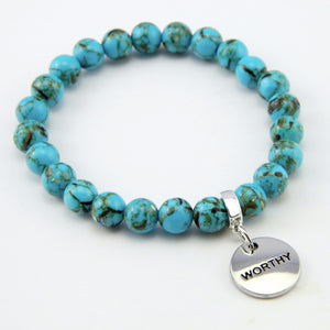 Teal coloured stone bracelet with word charm and silver clip.