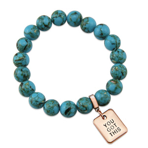 Teal coloured stone bracelet with word charm and rose gold clip.