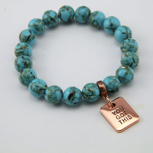 Teal coloured stone bracelet with word charm and rose gold clip.