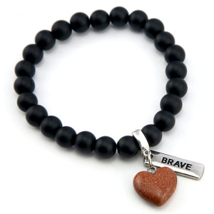 Matt black onyx stone bead bracelet with copper sparkle sandstone heart charm and inspiring word charms in silver.
