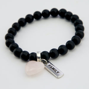 Matt black onyx stone bead bracelet with rose quart6z stone heart pendnat charm and silver inspiring word charms.