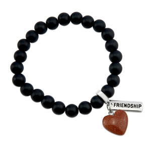 Matt black onyx stone bead bracelet with copper sparkle sandstone heart charm and inspiring word charms in silver.