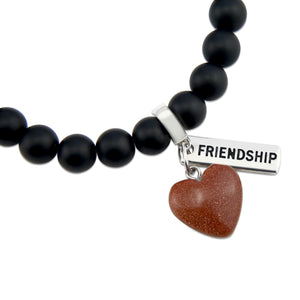 Matt black onyx stone bead bracelet with copper sparkle sandstone heart charm and inspiring word charms in silver.
