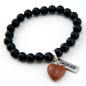 Matt black onyx stone bead bracelet with copper sparkle sandstone heart charm and inspiring word charms in silver.