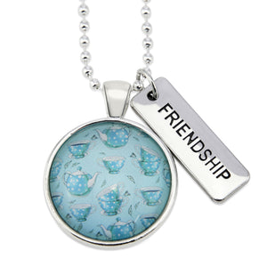 Teal tea cup print pendant necklace in bright silver with friendship charm.