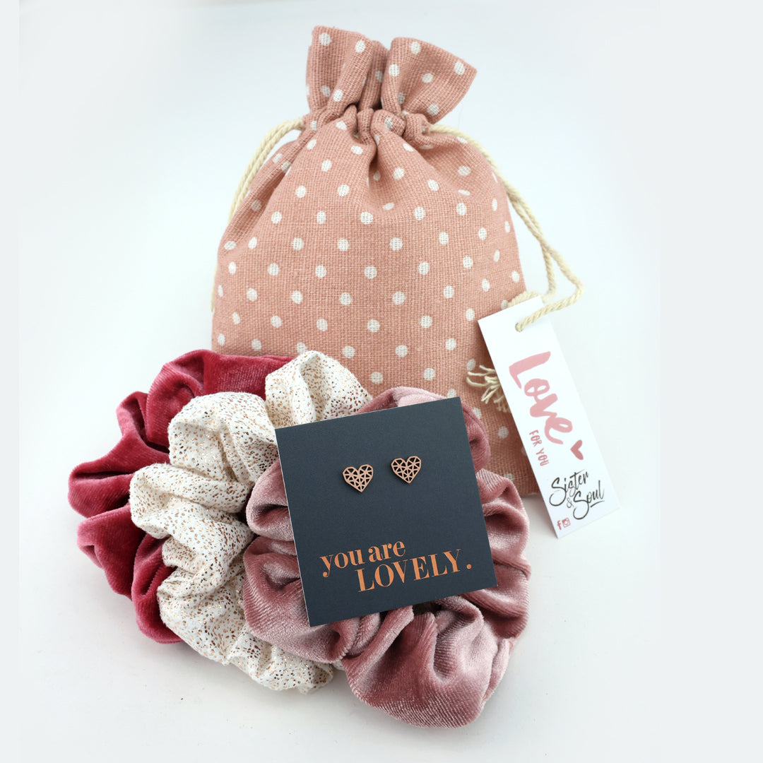 Set of scrunchies with a card and a polka dot drawstring bag on a white background