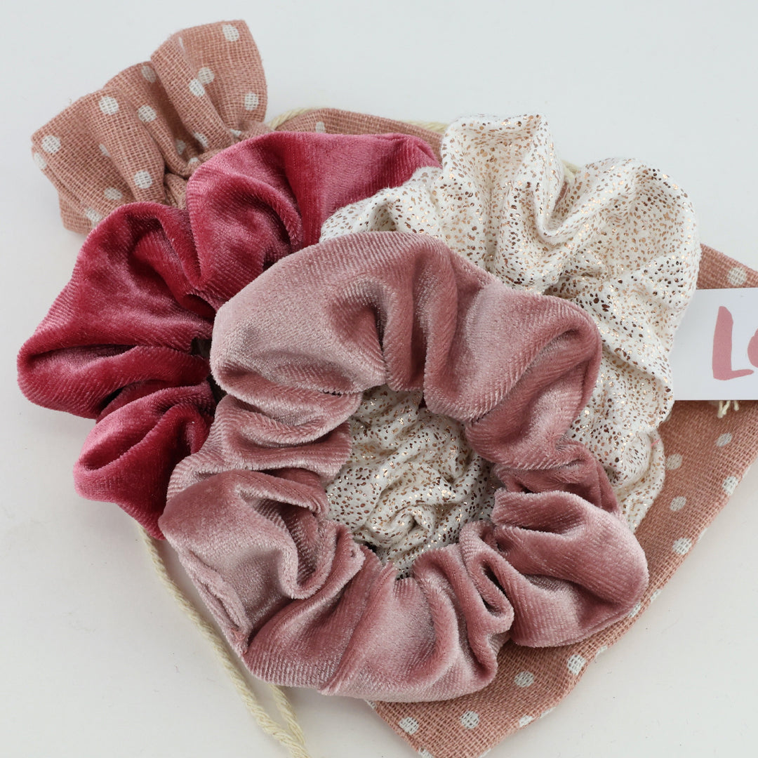 Set of four scrunchies in different designs on a white background