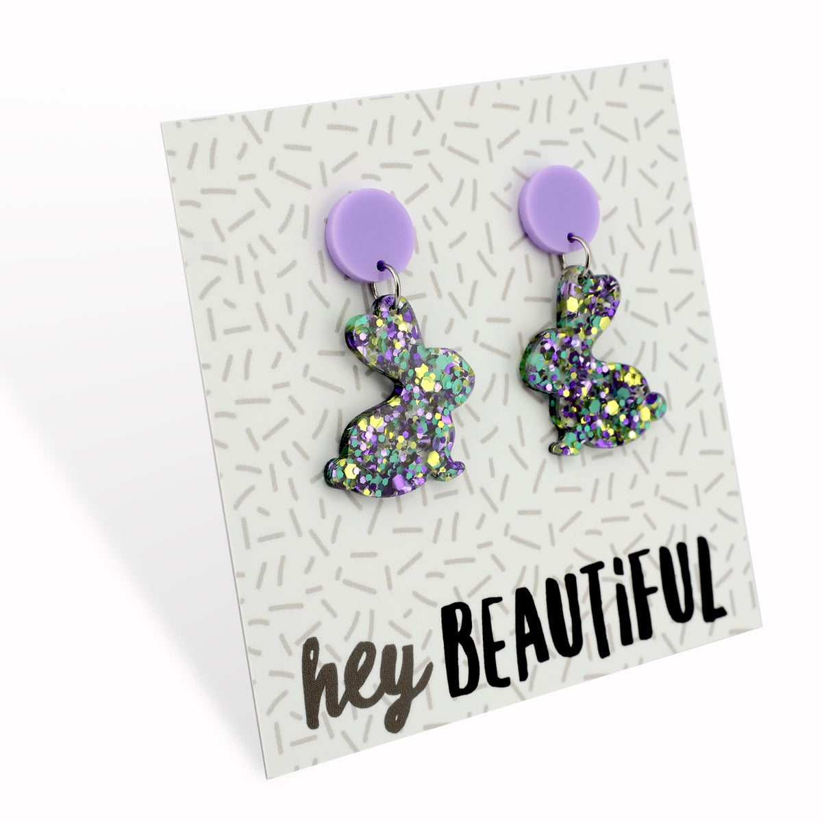 A pair of colorful acrylic bunny-shaped earrings on a card with 'hey beautiful' text.