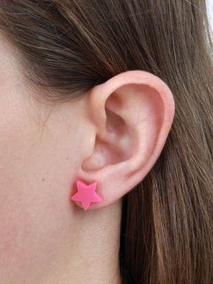 Beautiful Strong Unique pink acrylic star stud earrings worn on an ear to show size and fit