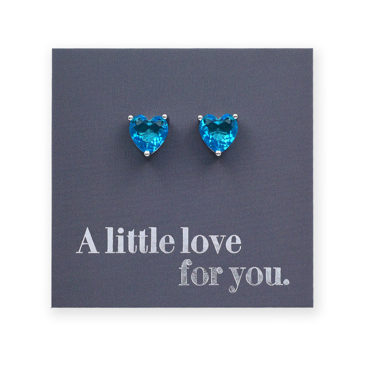 Blue heart-shaped earrings on a card with 'A little love for you.' text