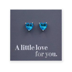 Blue heart-shaped earrings on a card with 'A little love for you.' text