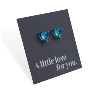 Blue heart-shaped earrings on a black card with 'A little love for you' text.