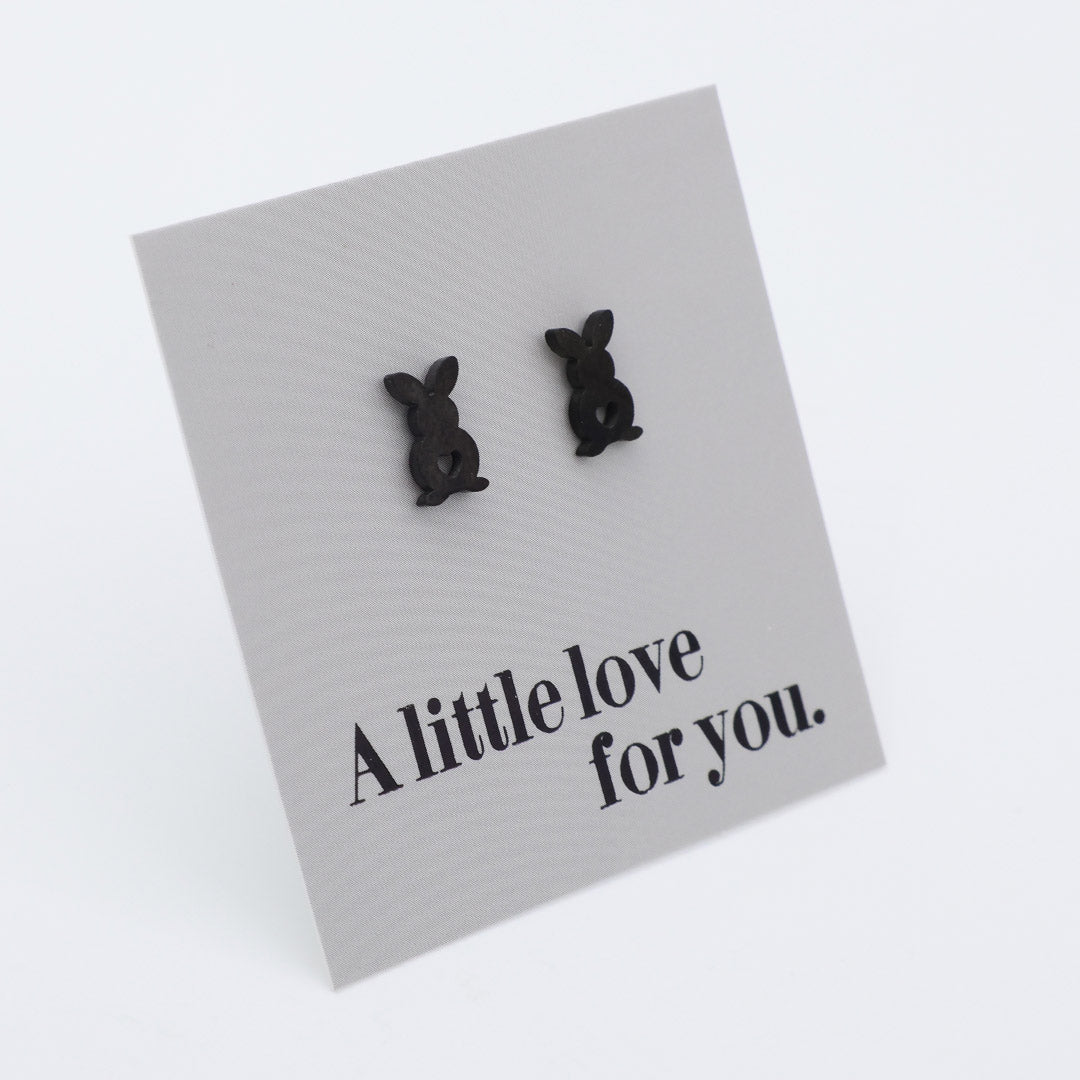 Black bunny-shaped earrings on a card with 'A little love for you.' text