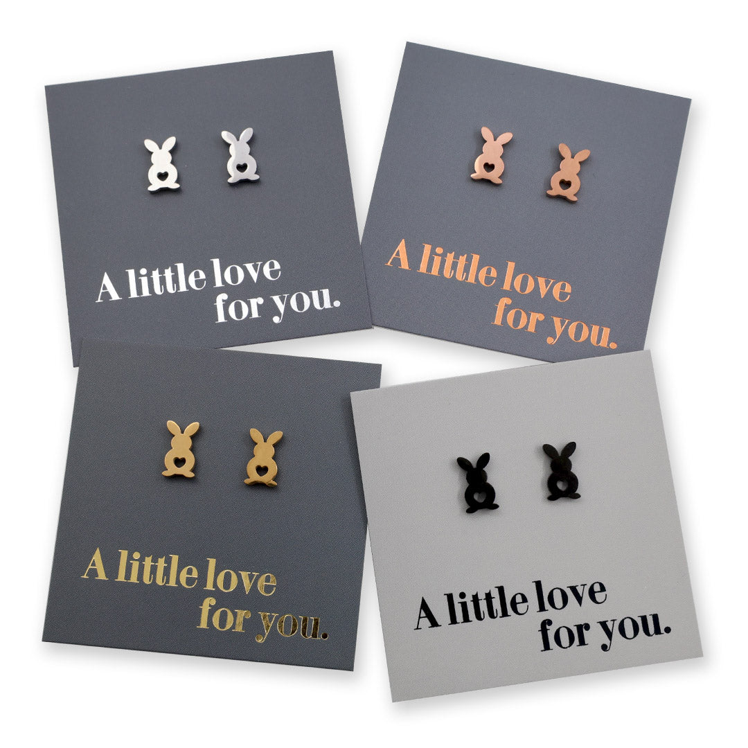 Four pairs of earrings on gray cards with 'A little love for you.' text.