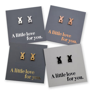 Four pairs of earrings on gray cards with 'A little love for you.' text.