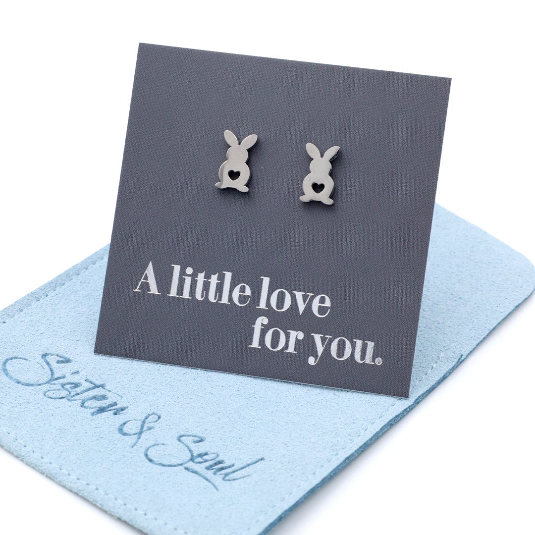 Bunny-shaped earrings on a card with 'A little love for you' text, displayed on a blue card with 'Sister & Soul' branding.