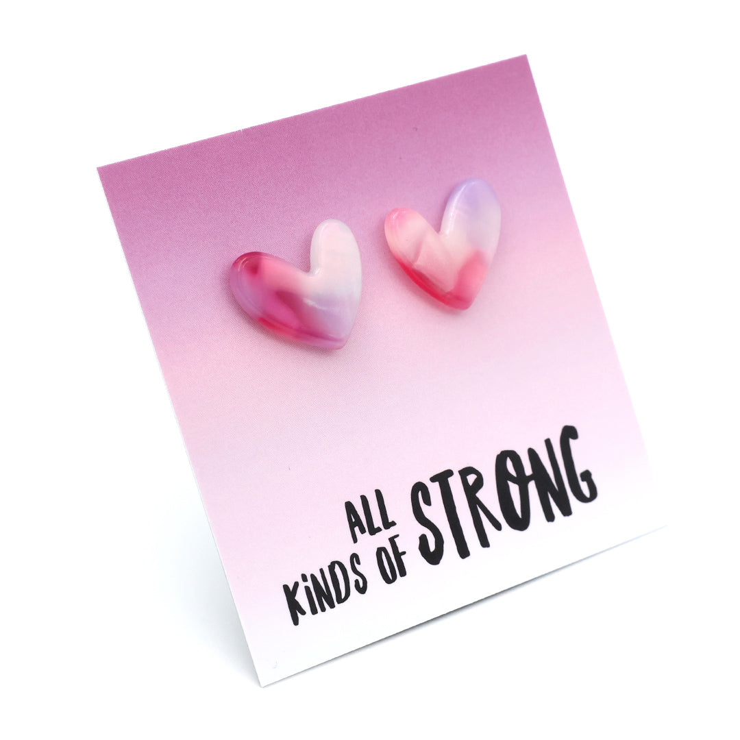Heart-shaped earrings on a card with 'all kinds of strong' text