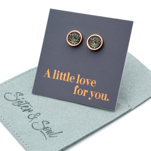 Pair of earrings on a card with 'A little love for you' text, displayed on a branded jewelry pouch.