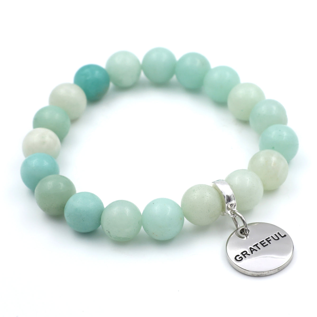 Turquoise and white beaded bracelet with a 'GRATEFUL' charm on a white background