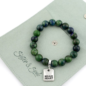 Green beaded bracelet with 'Brave Heart' charm on a green card, featuring the brand 'Sister & Soul'.