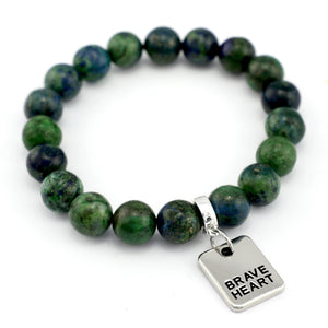 Green beaded bracelet with a 'Brave Heart' tag on a white background
