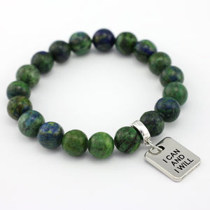 Green beaded bracelet with a silver tag on a white background