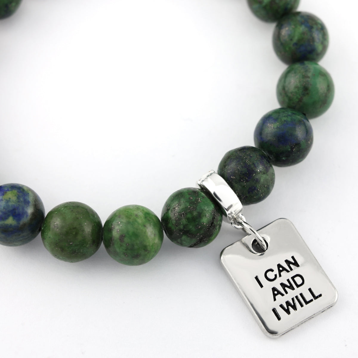 Green beaded bracelet with a silver 'I Can And I Will' charm on a white background
