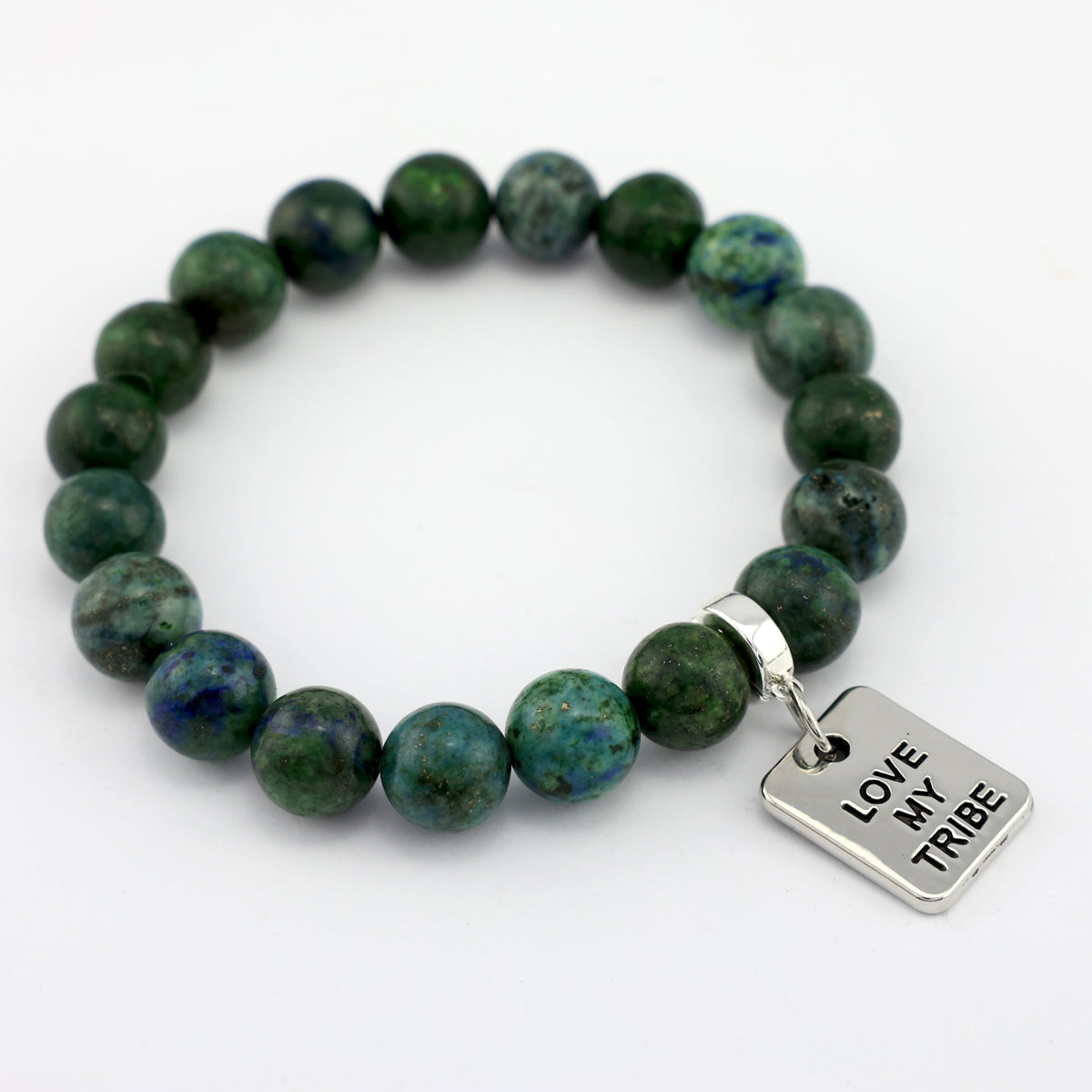 Green beaded bracelet with a silver charm on a white background