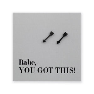 A square gray card or plaque with the text 'Babe, YOU GOT THIS!' in black serif font, with two small black arrowhead studs near the top center, shown on a white background.