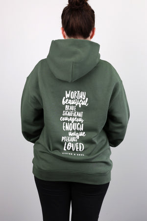 Person wearing a green hoodie with motivational text on the back against a white background