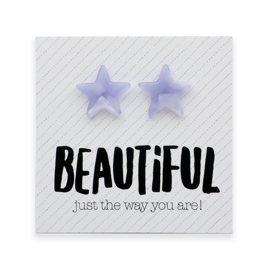 A pair of light purple star-shaped stud earrings displayed on a white square card with the text 'BEAUTIFUL just the way you are!' in black lettering.