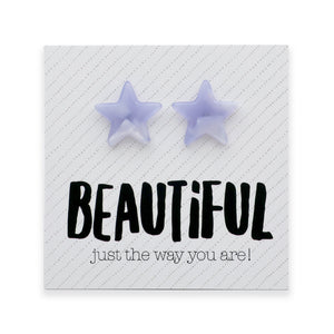 A pair of light purple star-shaped stud earrings displayed on a white square card with the text 'BEAUTIFUL just the way you are!' in black lettering.