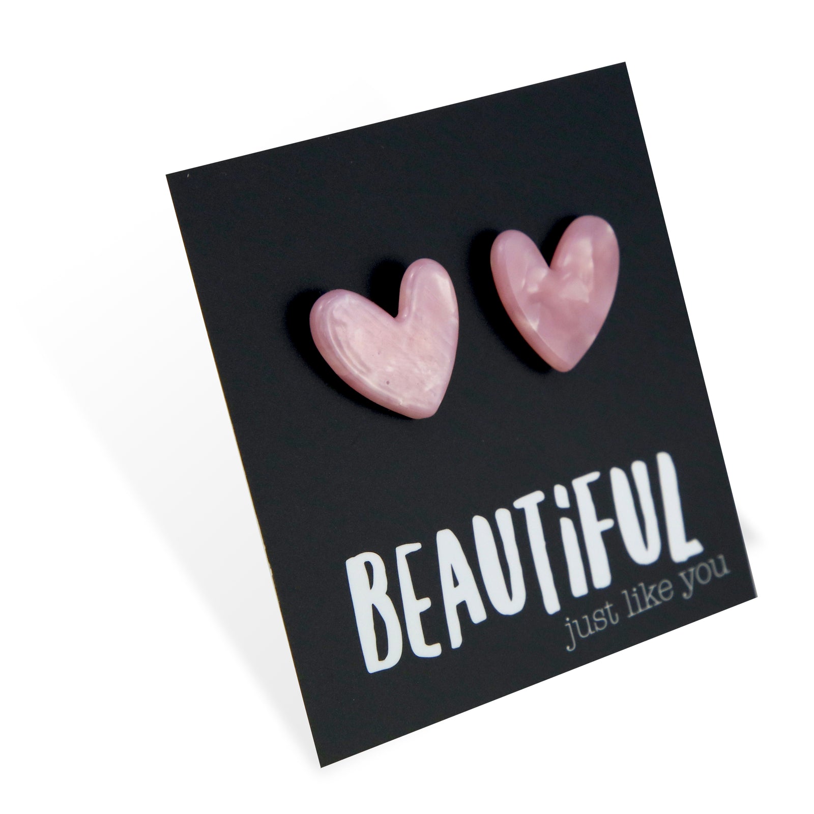 Heart-shaped pink earrings on a black card with 'BEAUTiFUL just like you' text.