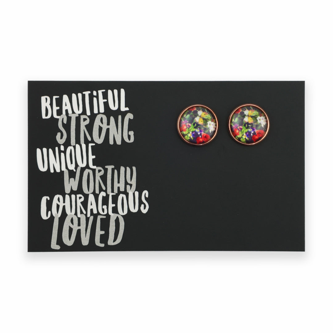 Floral stud earrings on a black card with motivational text