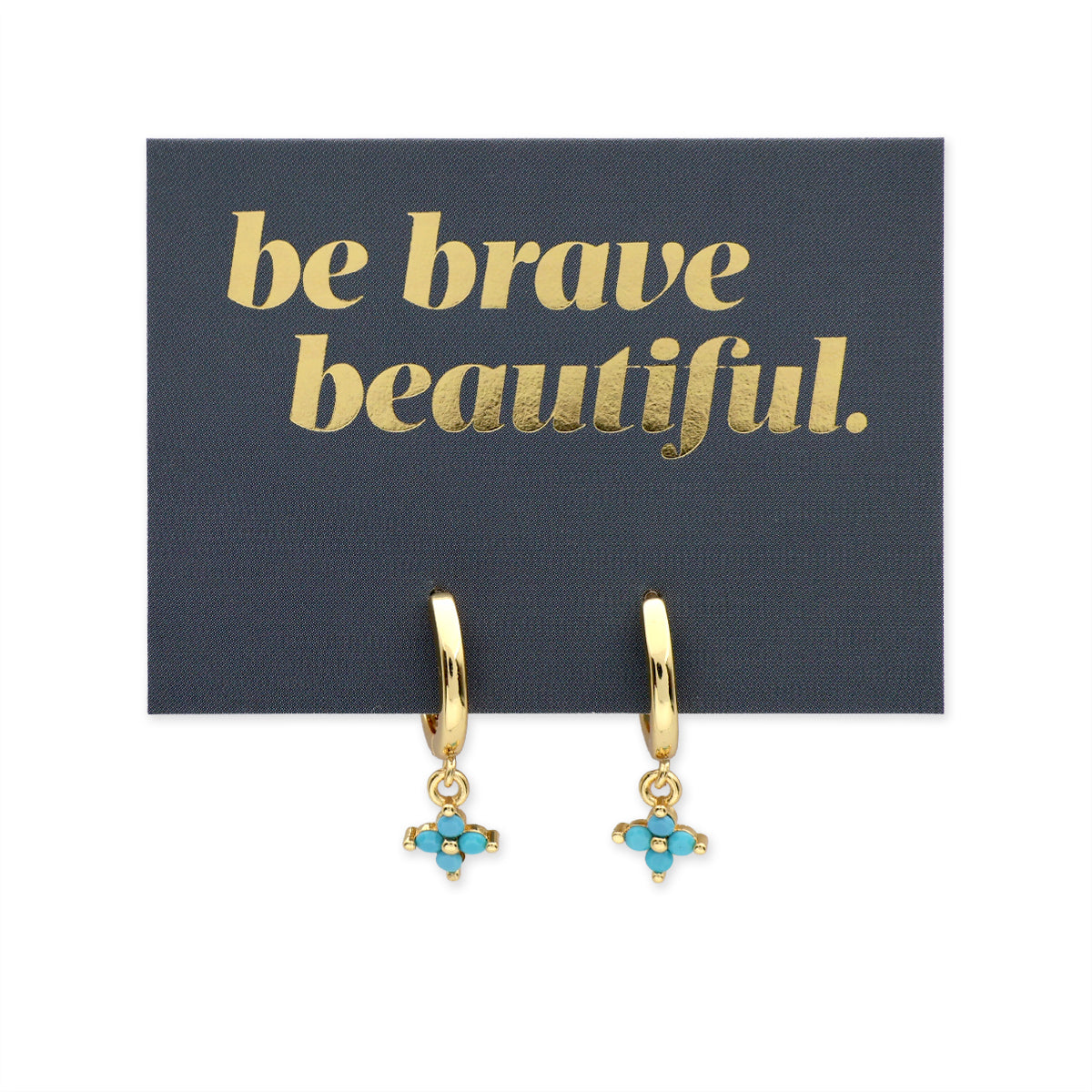 Gold hoop earrings with turquoise charms on a 'be brave beautiful' card.