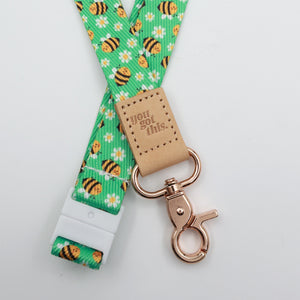 You Got This embossed on a green bee and daisy lanyard with tan trim and a lobster clasp.