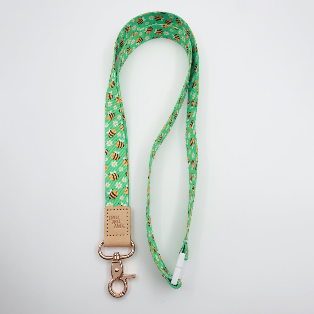 You Got This embossed on a green bee and daisy lanyard with tan trim and a lobster clasp.