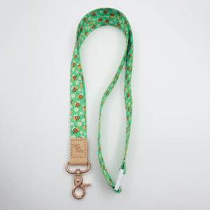You Got This embossed on a green bee and daisy lanyard with tan trim and a lobster clasp.