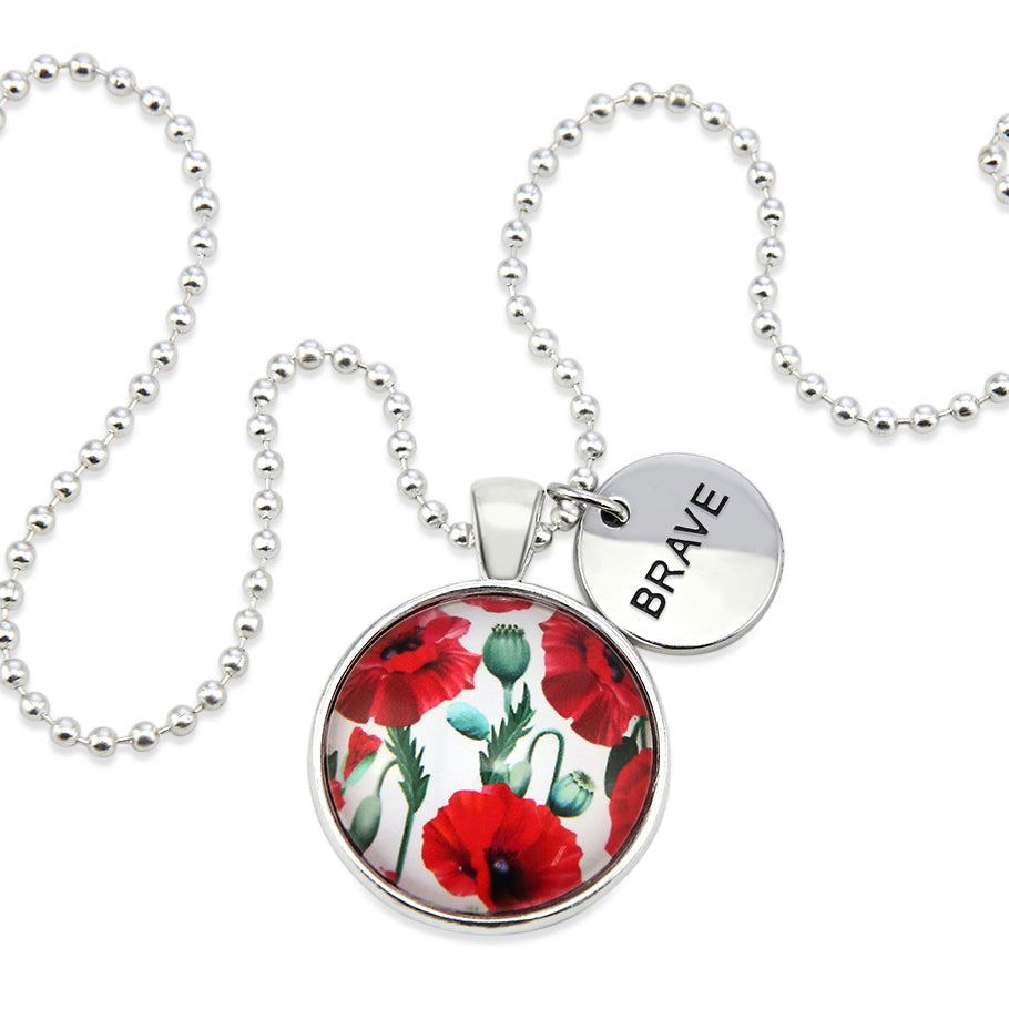 Necklace with floral pendant and 'BRAVE' charm on a white background
