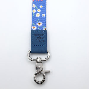Blue floral-patterned lanyard with metal clasp on a white background